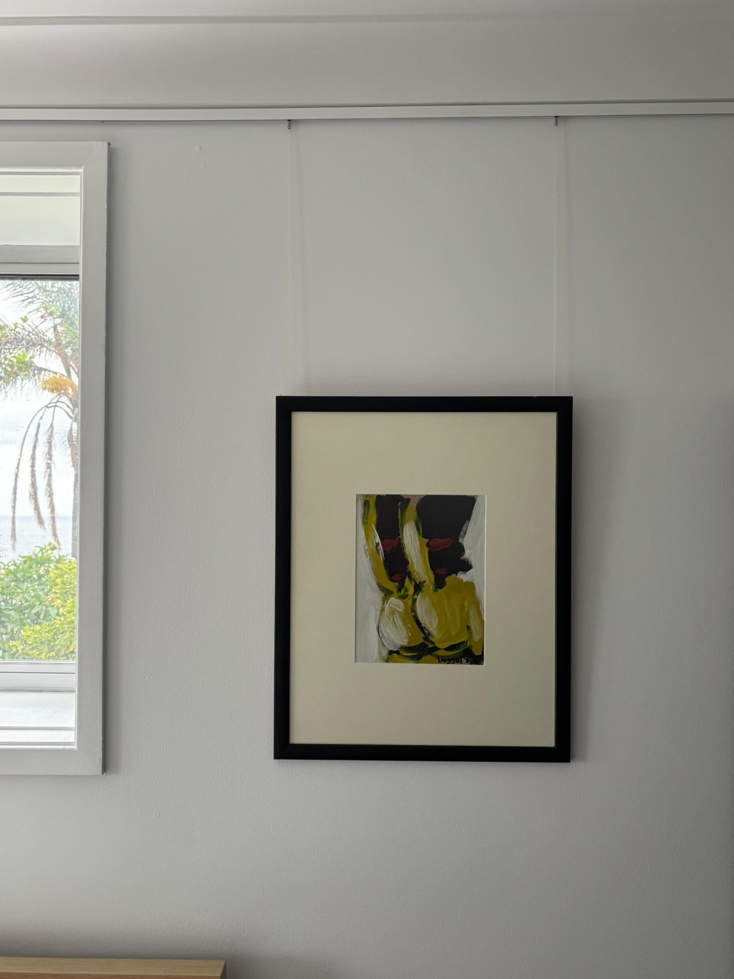 Single abstract framed print on white wall