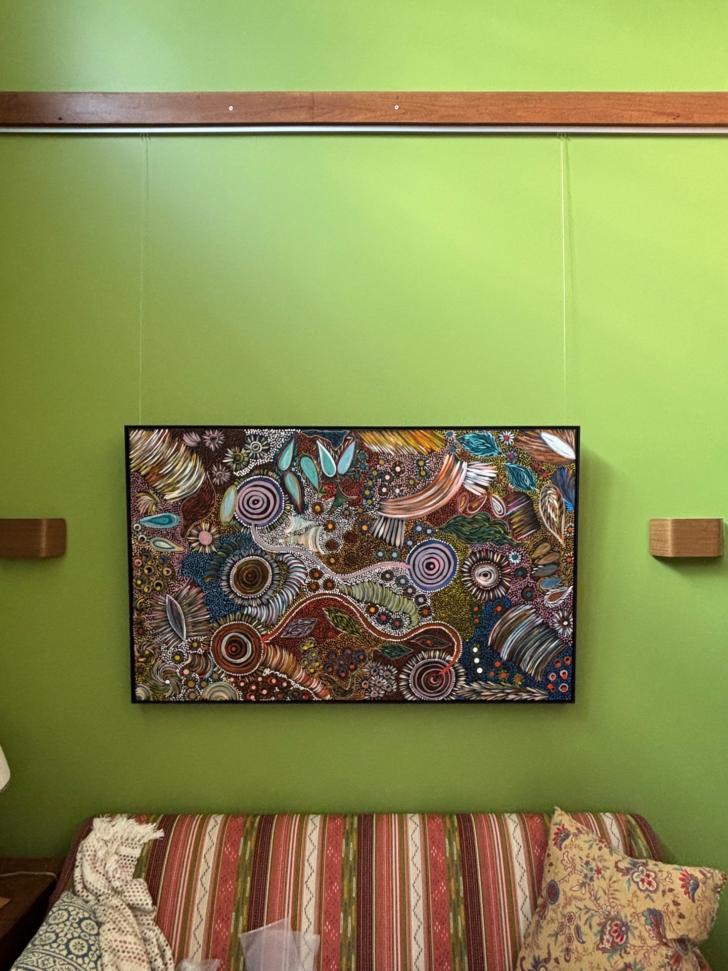 Framed artwork on green feature wall