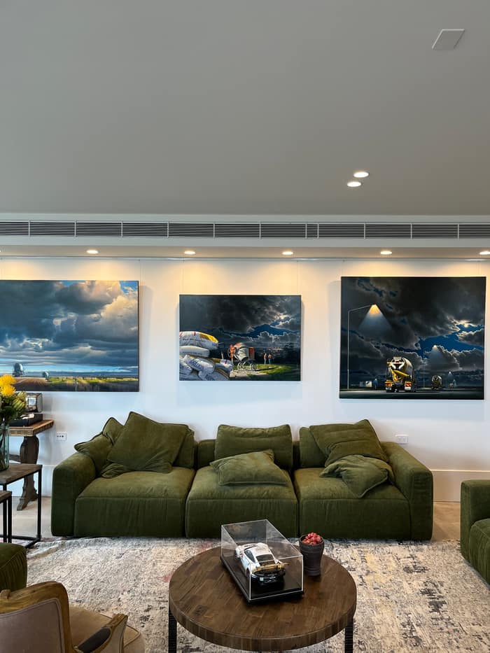 Contemporary living room with artwork suspended from a ceiling picture rail, available in Sydney