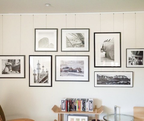 Salon-style gallery wall of black-and-white prints