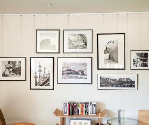 Gallery wall suspended from a discreet ceiling picture rail