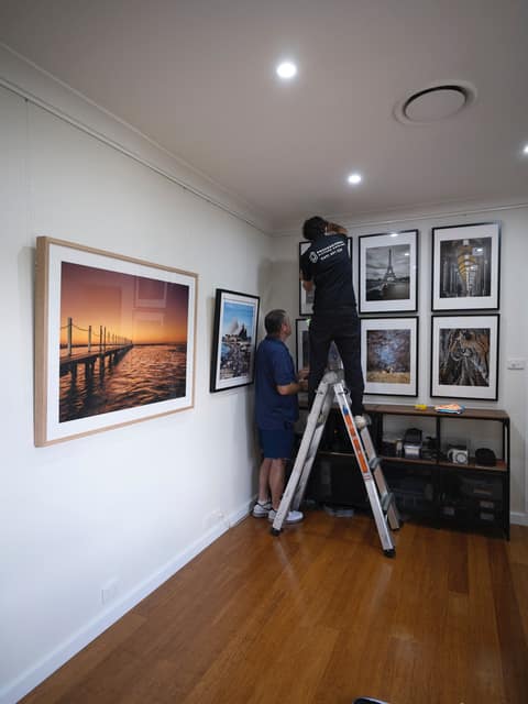 Gallery wall of framed photography on rail system