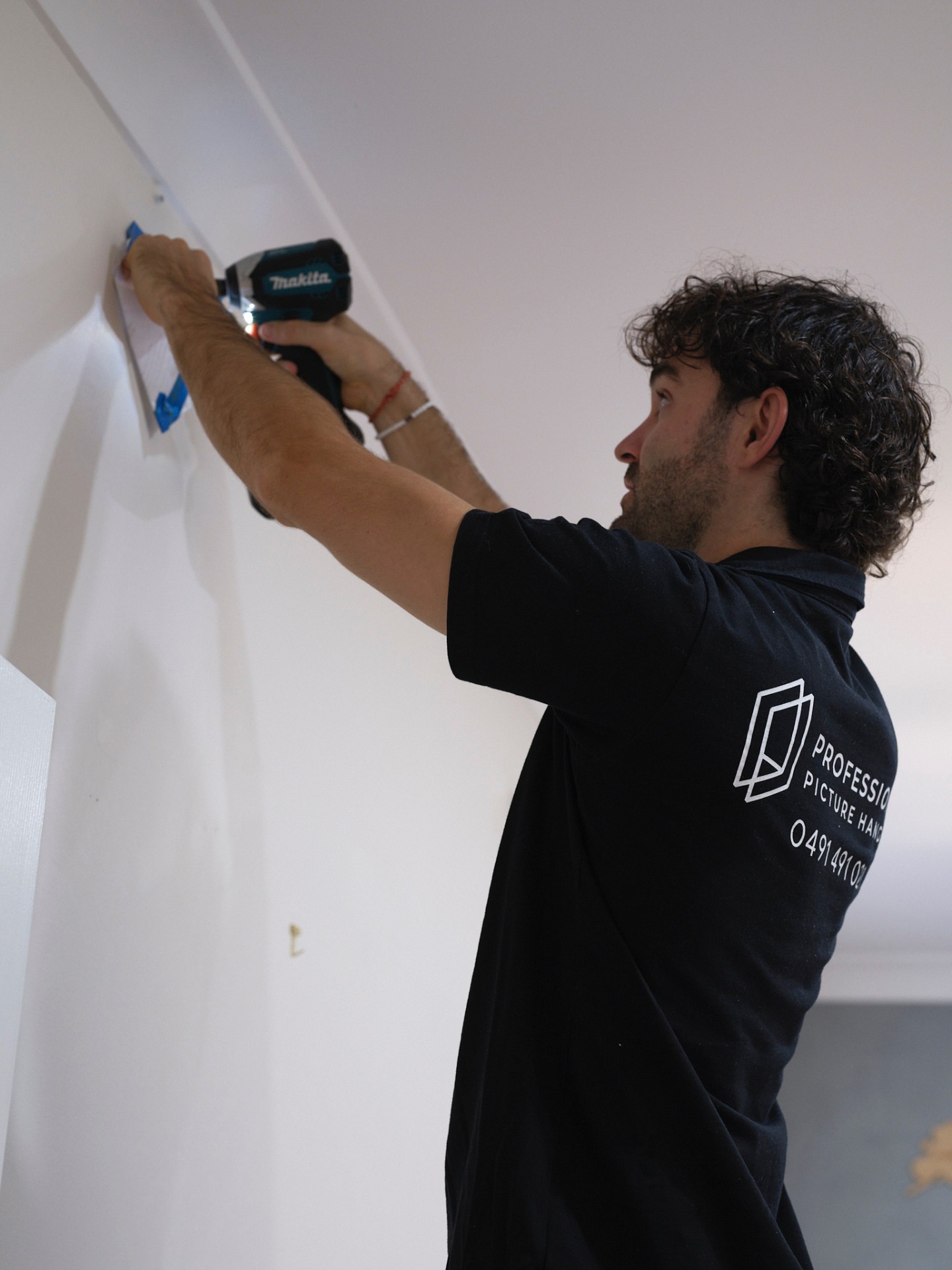 PPH installer fitting a picture rail